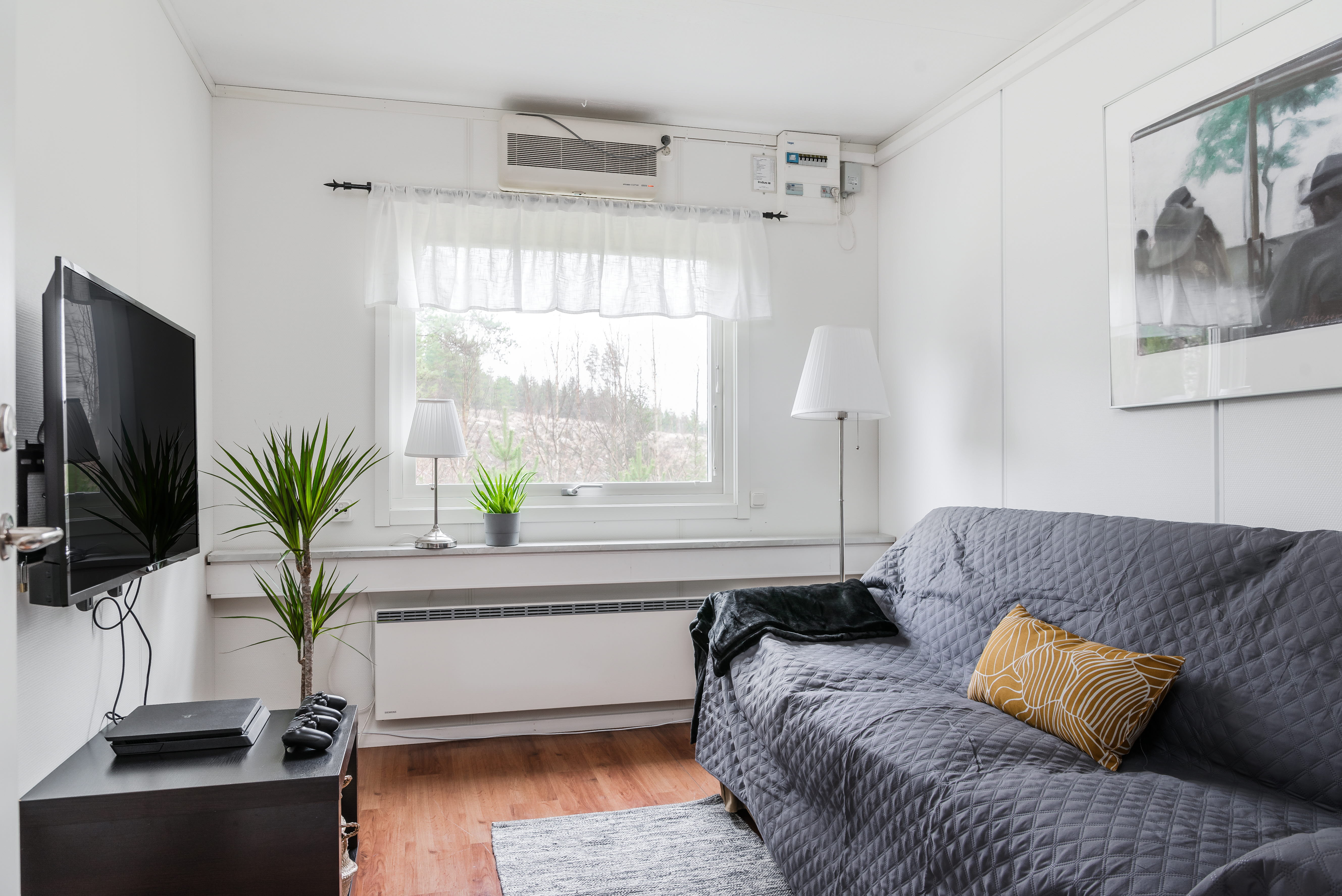 A living room filled with furniture and a large window