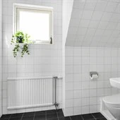 A restroom with a sink and a window