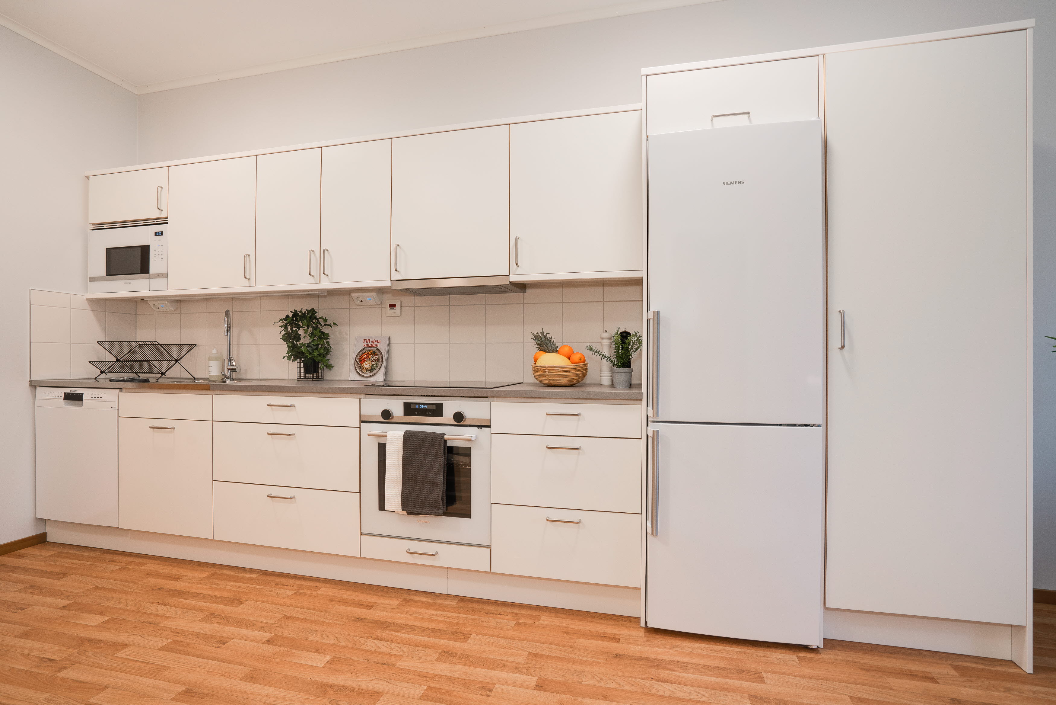 A kitchen with a stove and a refrigerator