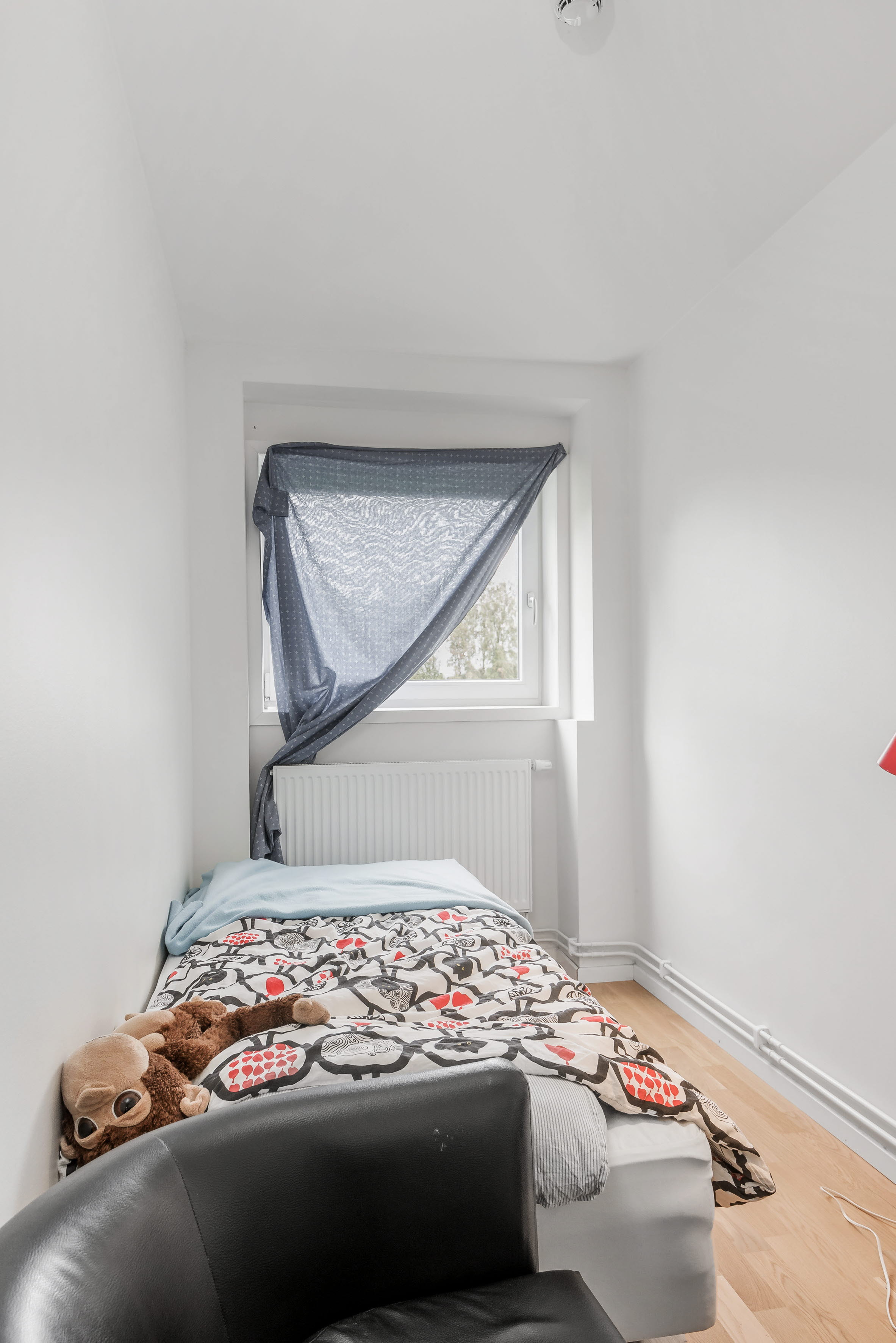 A bedroom with a bed in a room