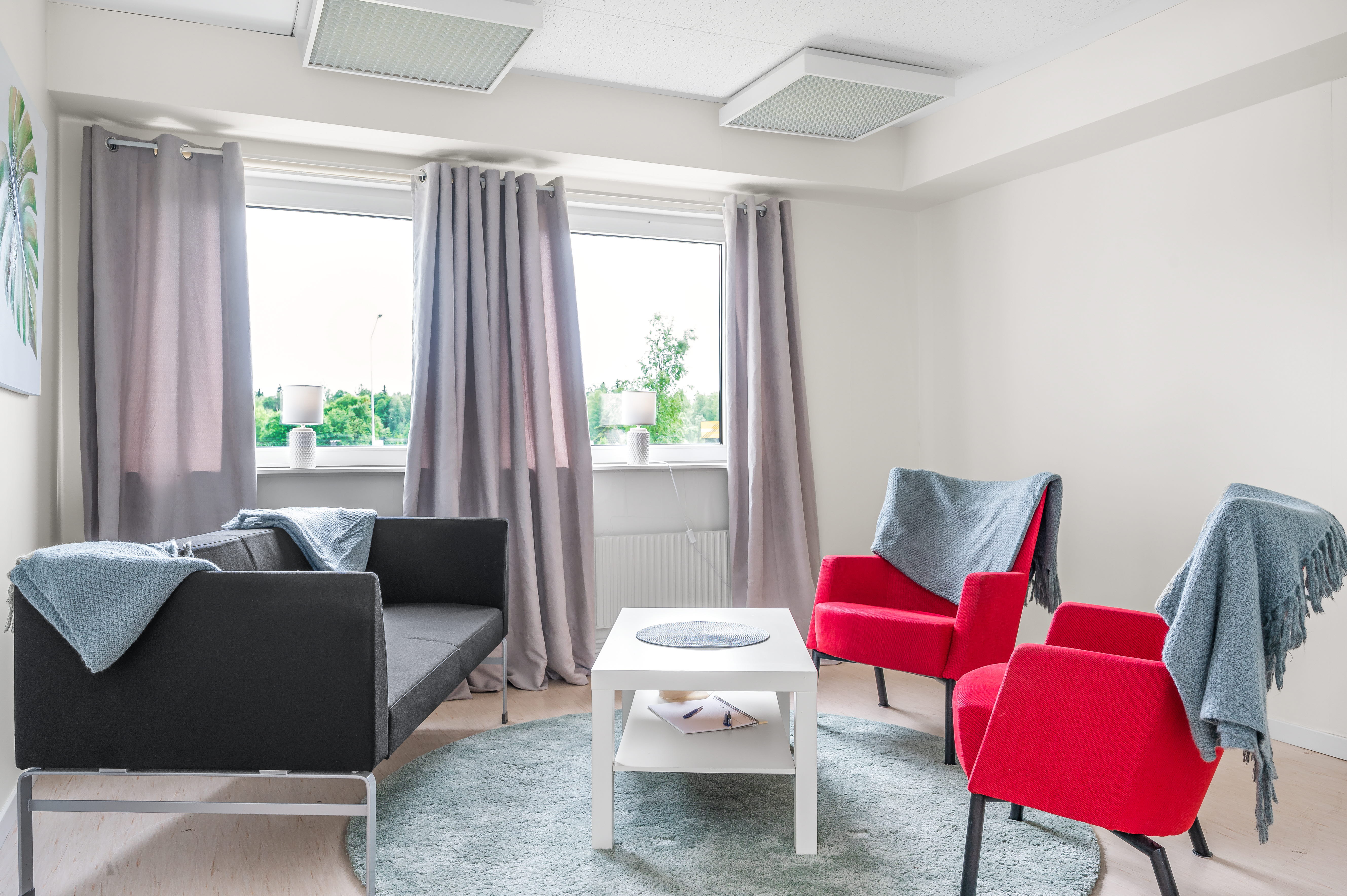 A living room filled with furniture and a large window