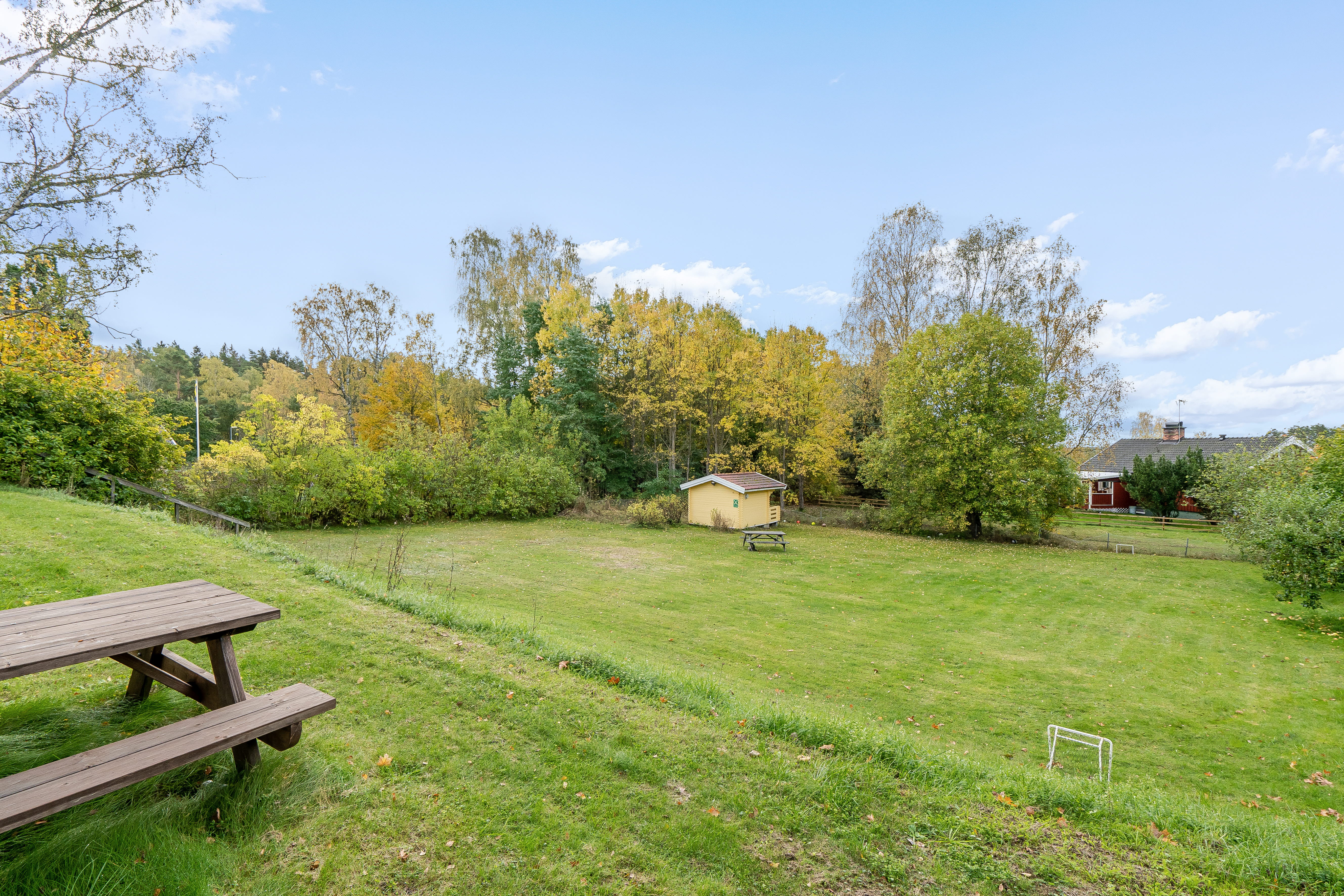 A wooden bench sitting on top of a lush green field
