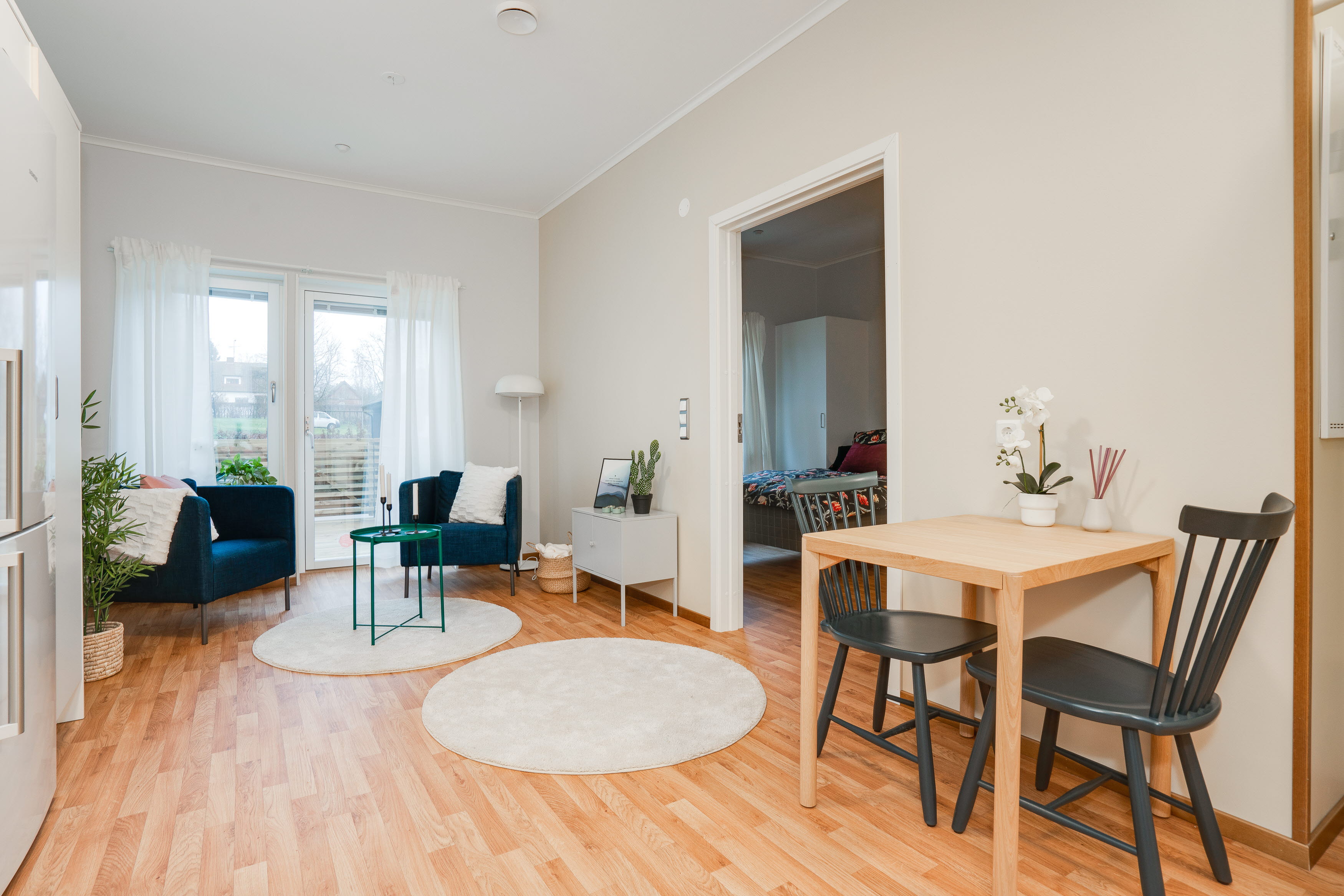 A living room filled with furniture and a wood floor