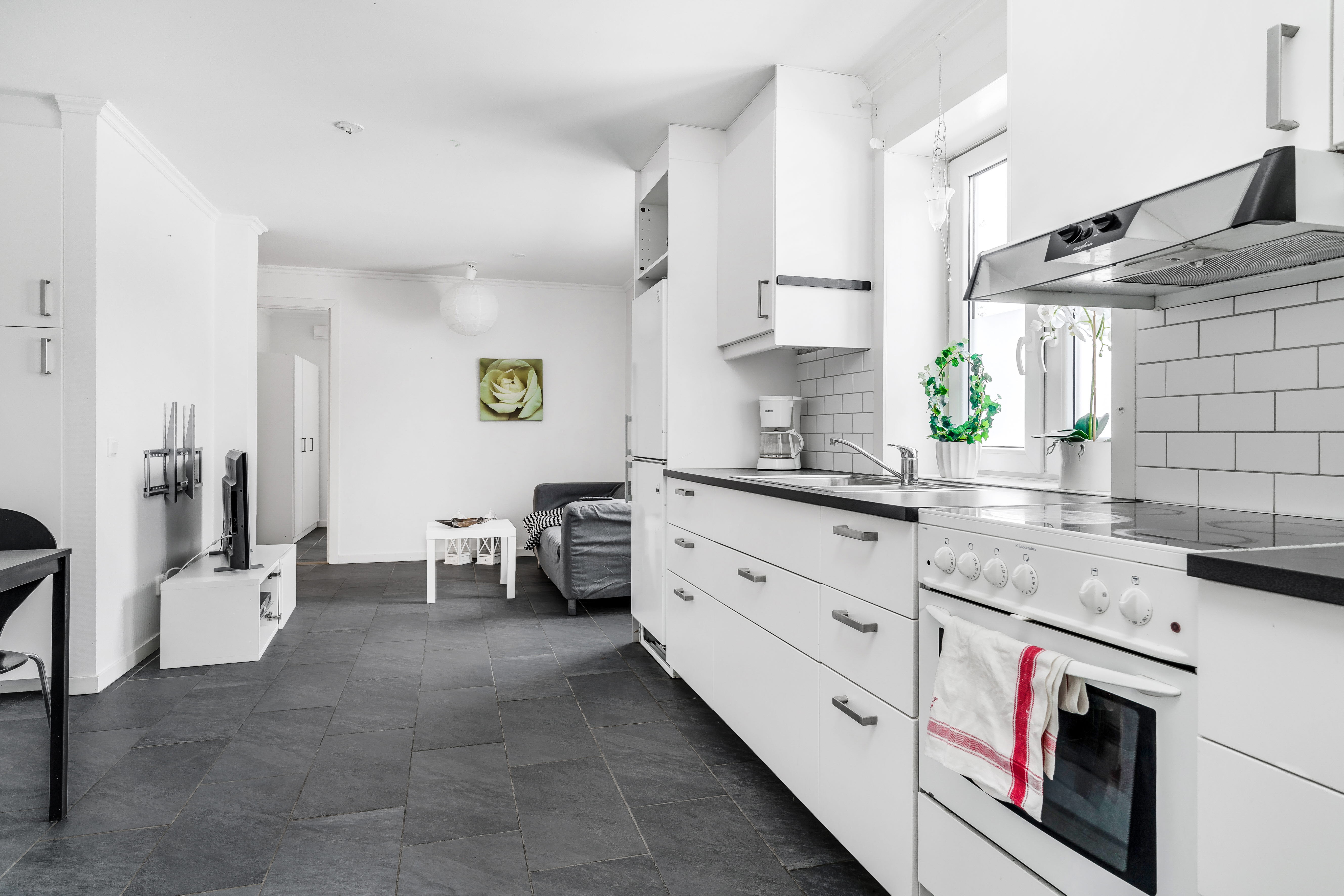 A kitchen with a stove and a refrigerator