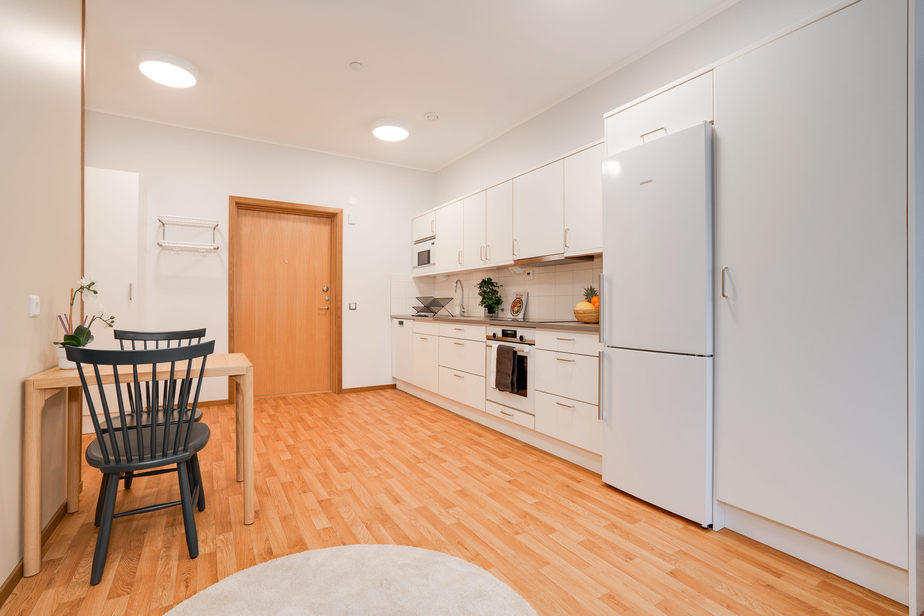A kitchen with a wood floor