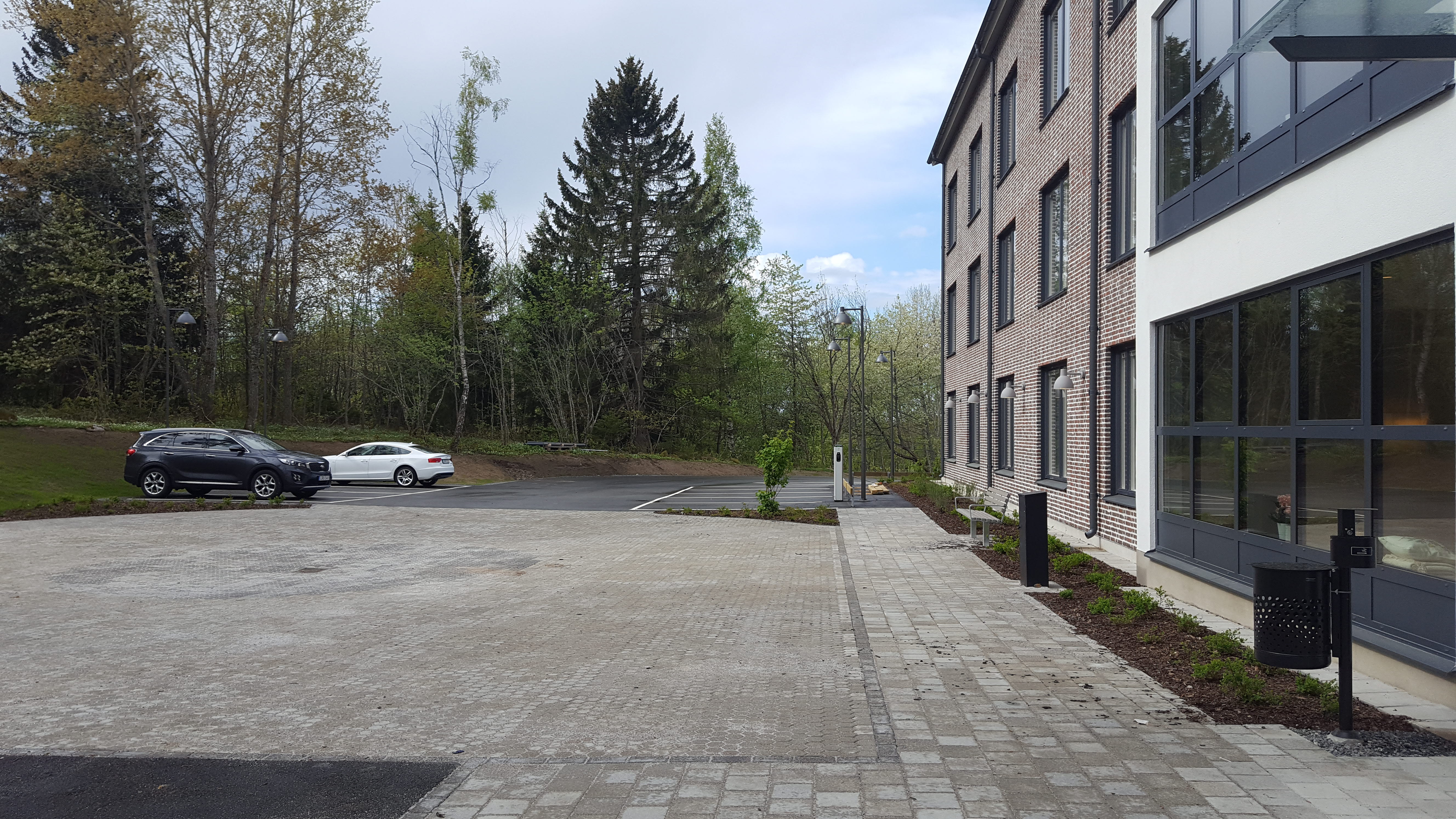 A street with cars parked on the side of a road