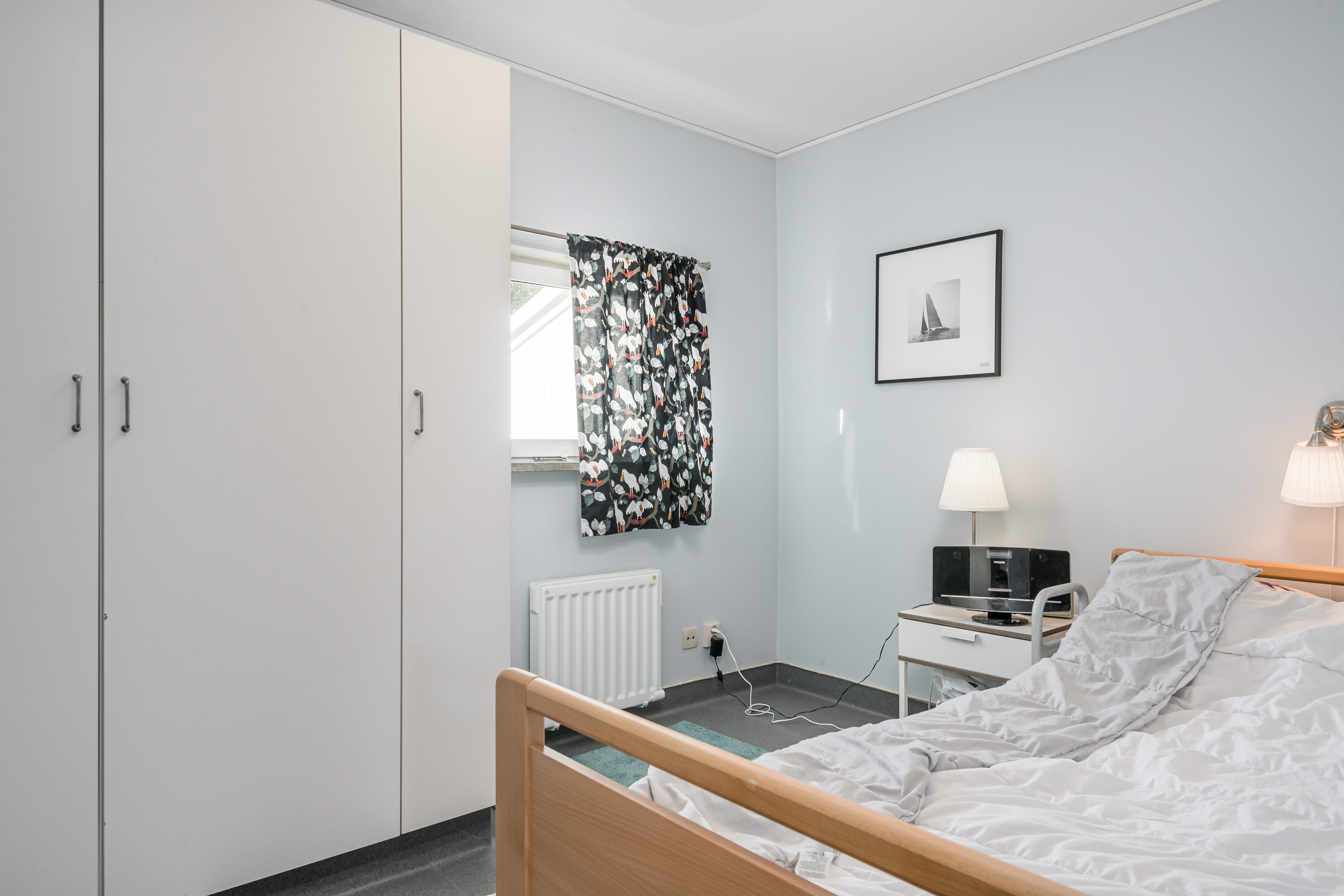 A bedroom with a bed in a room