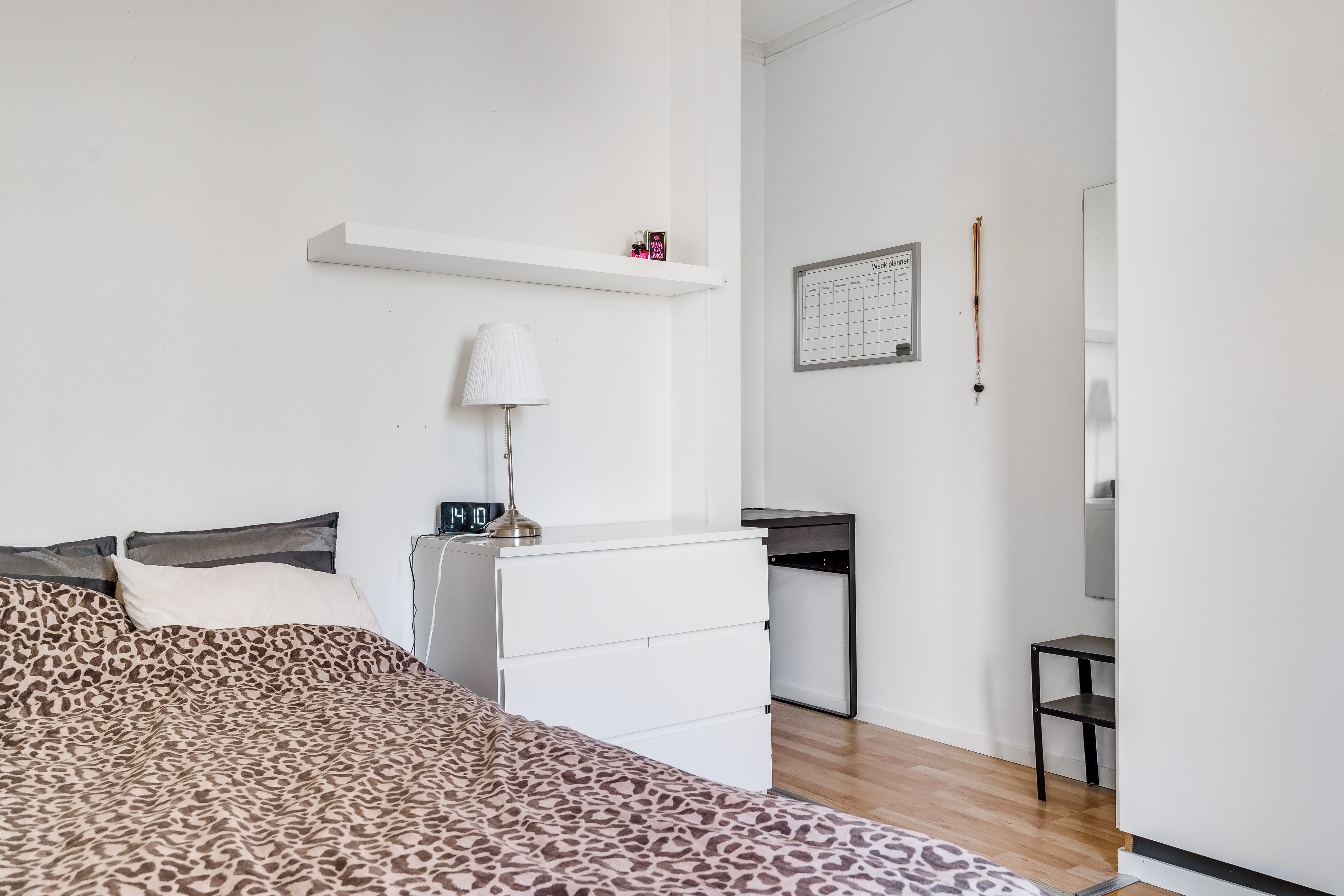 A bedroom with a bed in a room