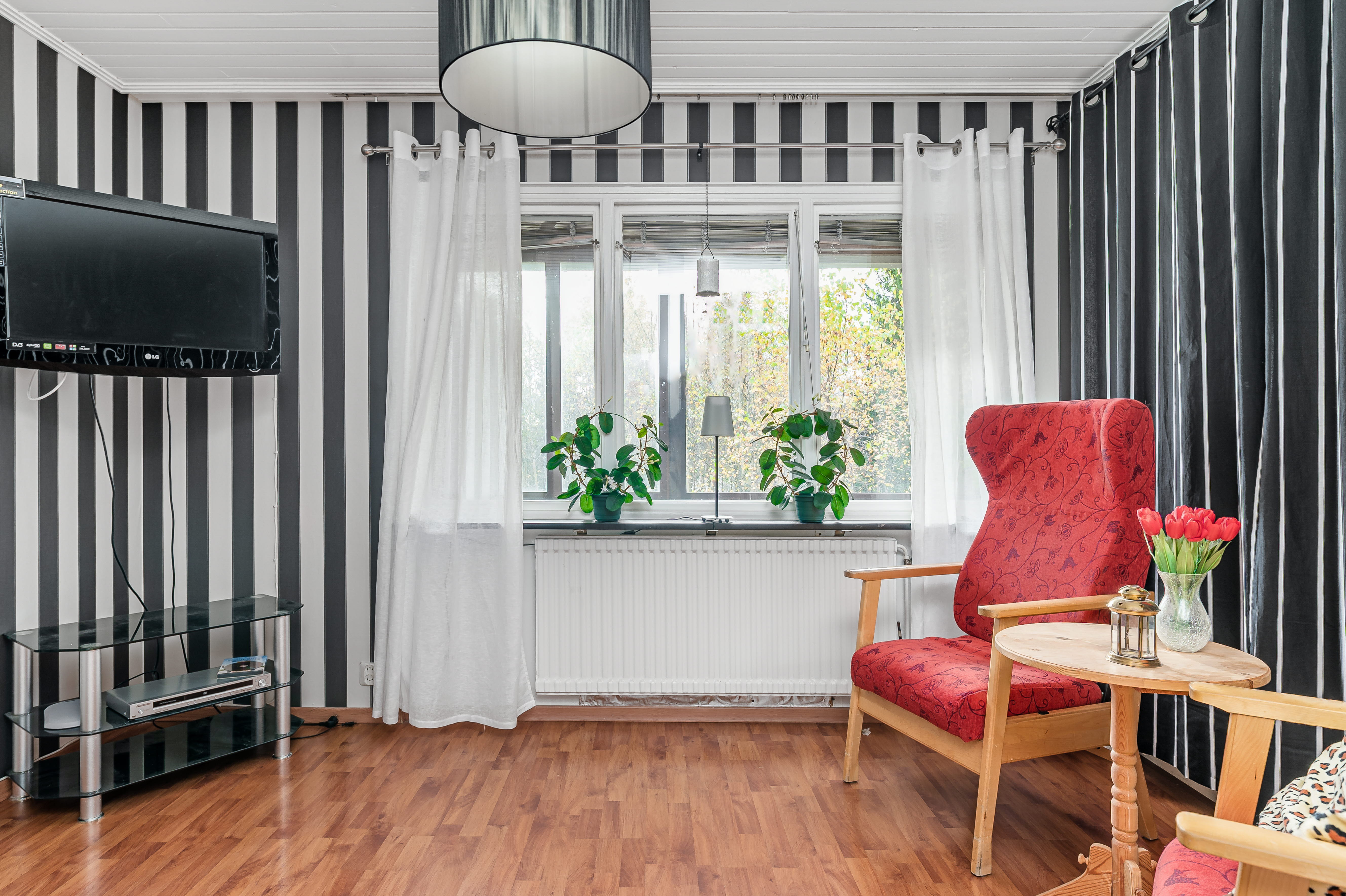 A living room filled with furniture on top of a hard wood floor