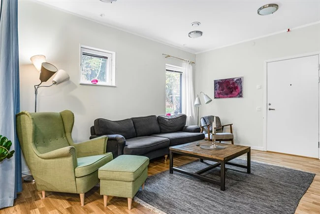 A living room filled with furniture and a wood floor