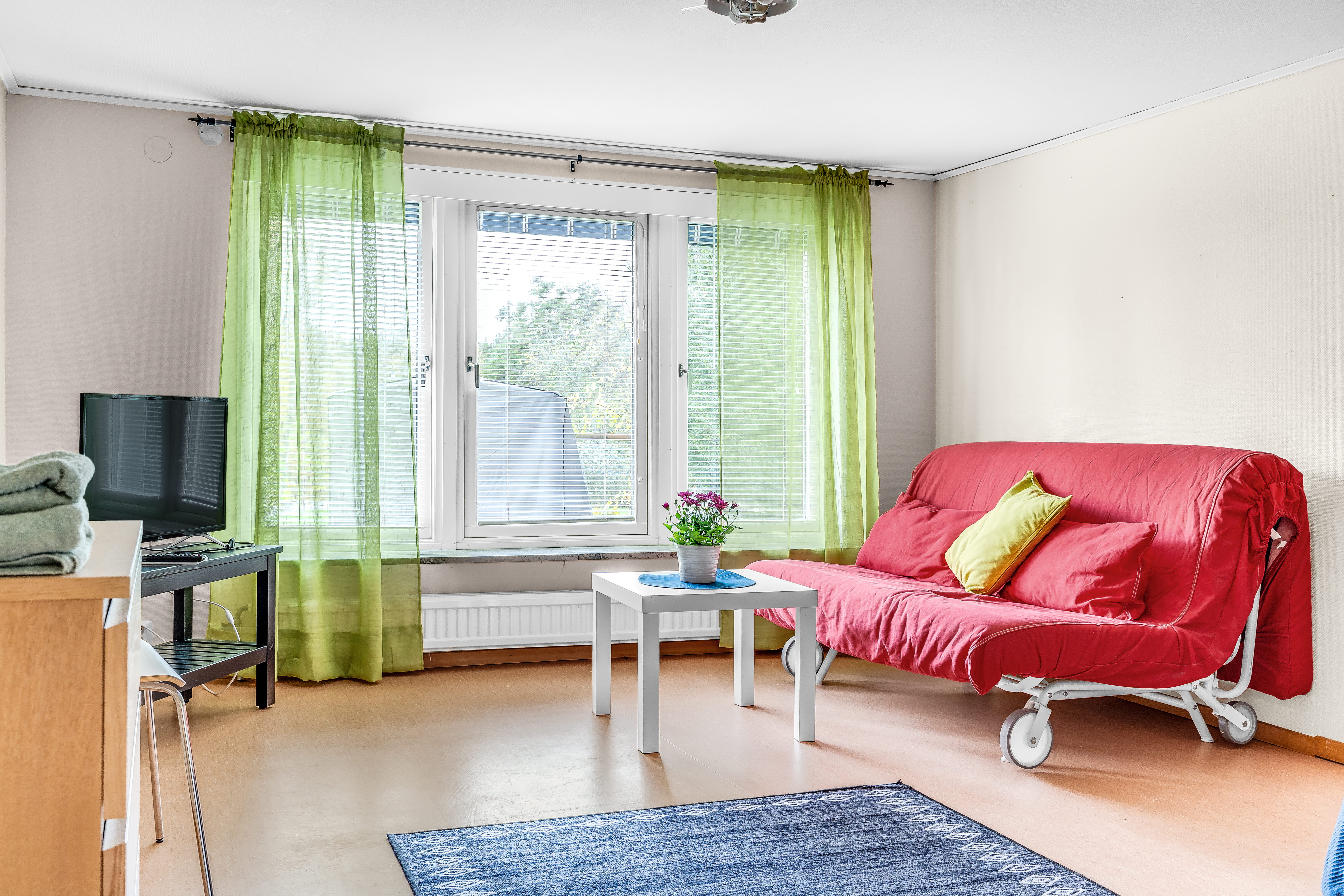 A living room filled with furniture and a large window