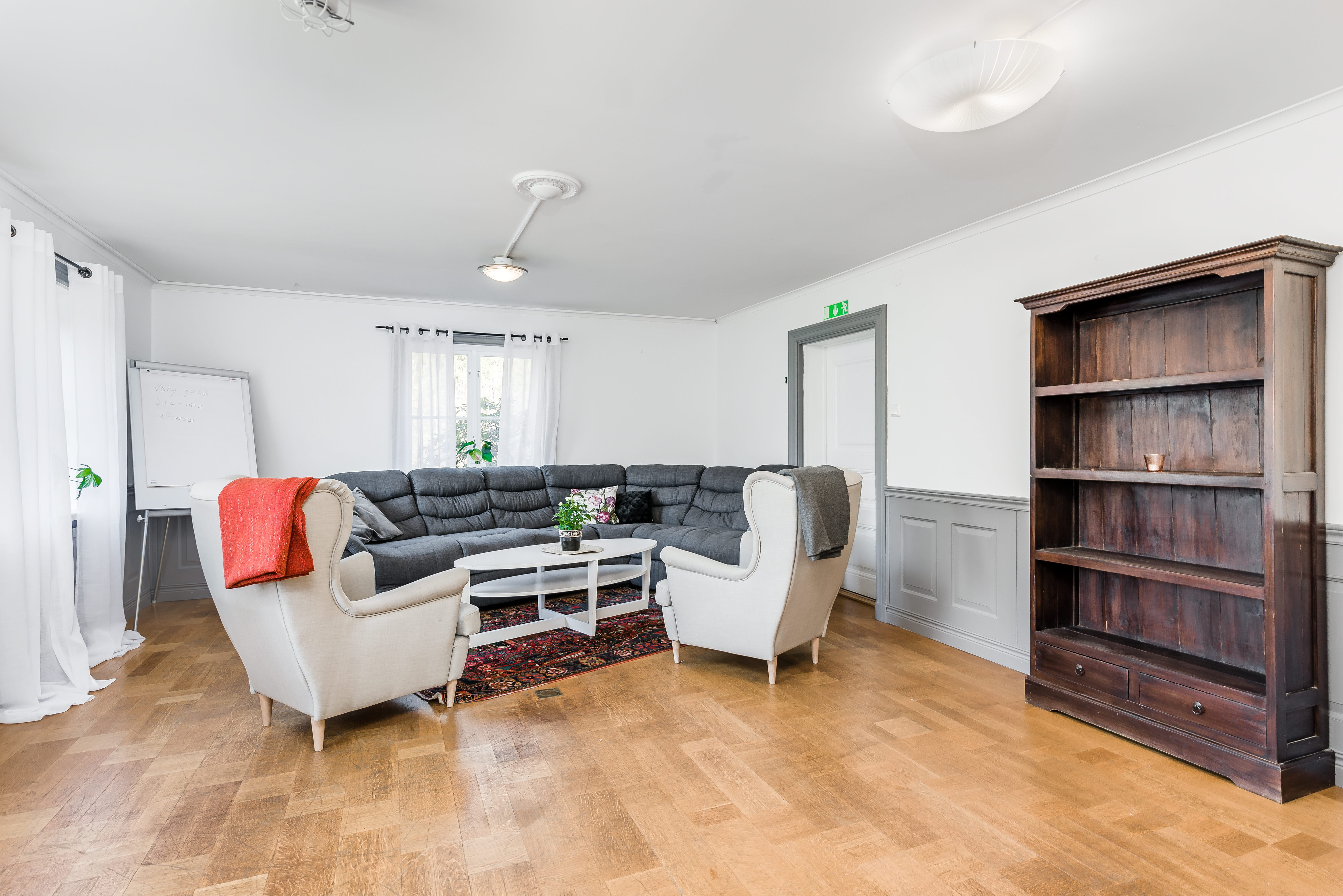 A living room filled with furniture on top of a hard wood floor