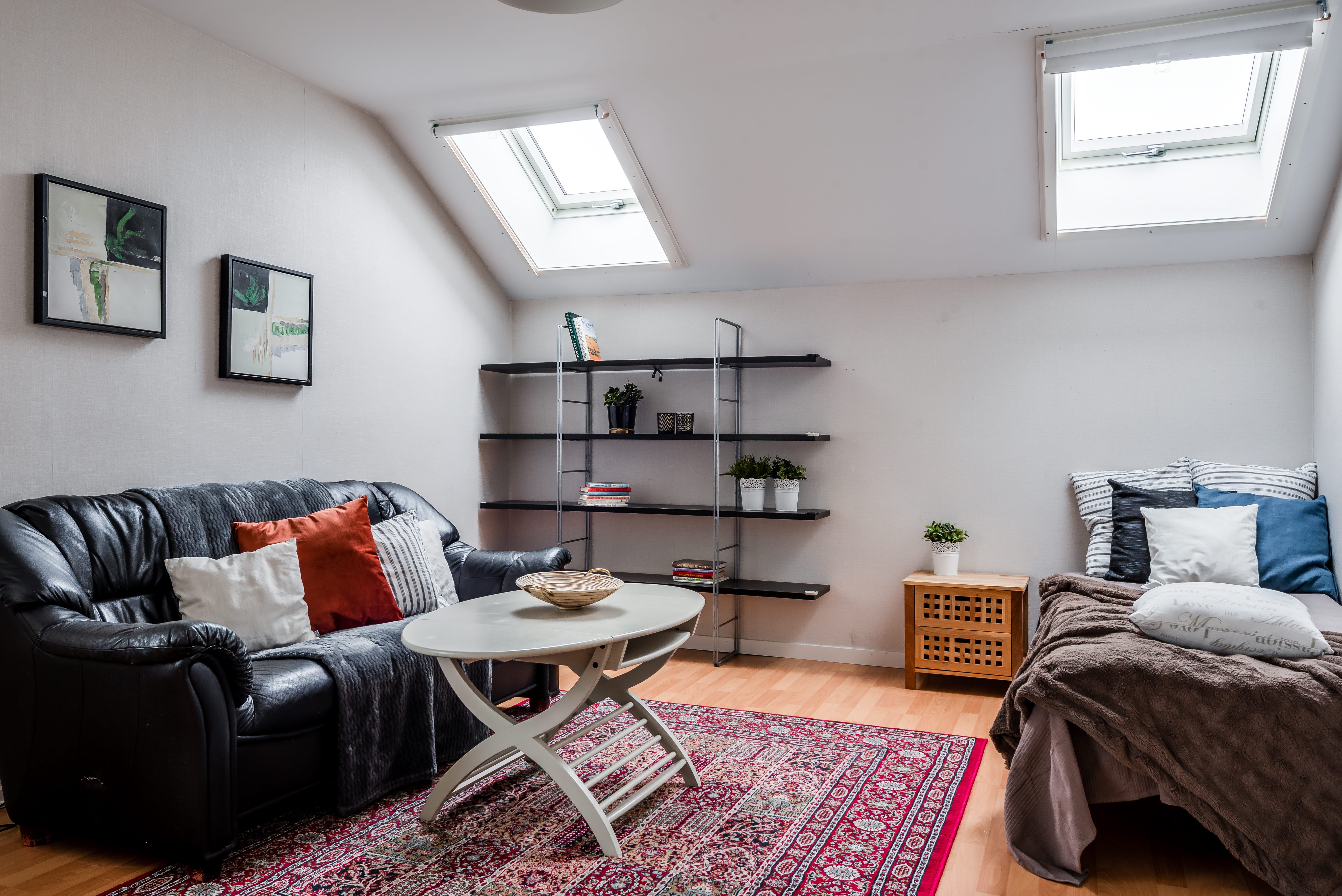 A bedroom with a bed and a chair in a room