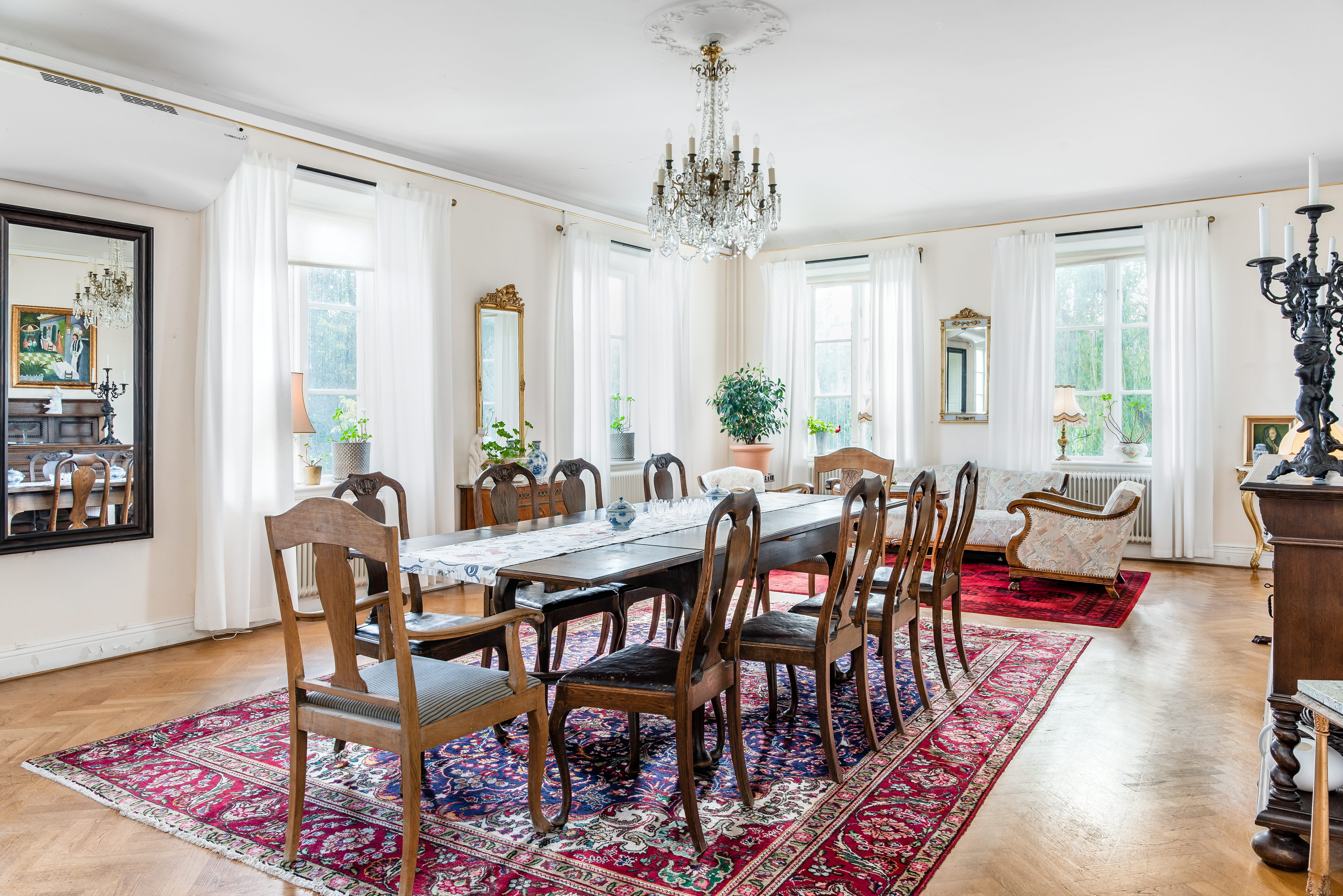 A living room filled with furniture and a fire place and a dining table