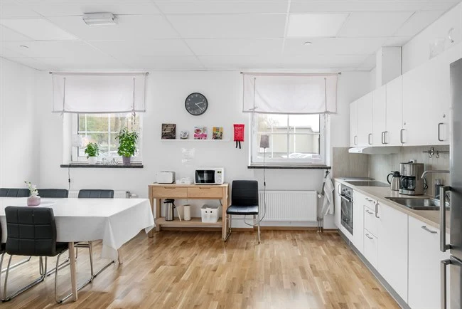 A kitchen with a wood floor