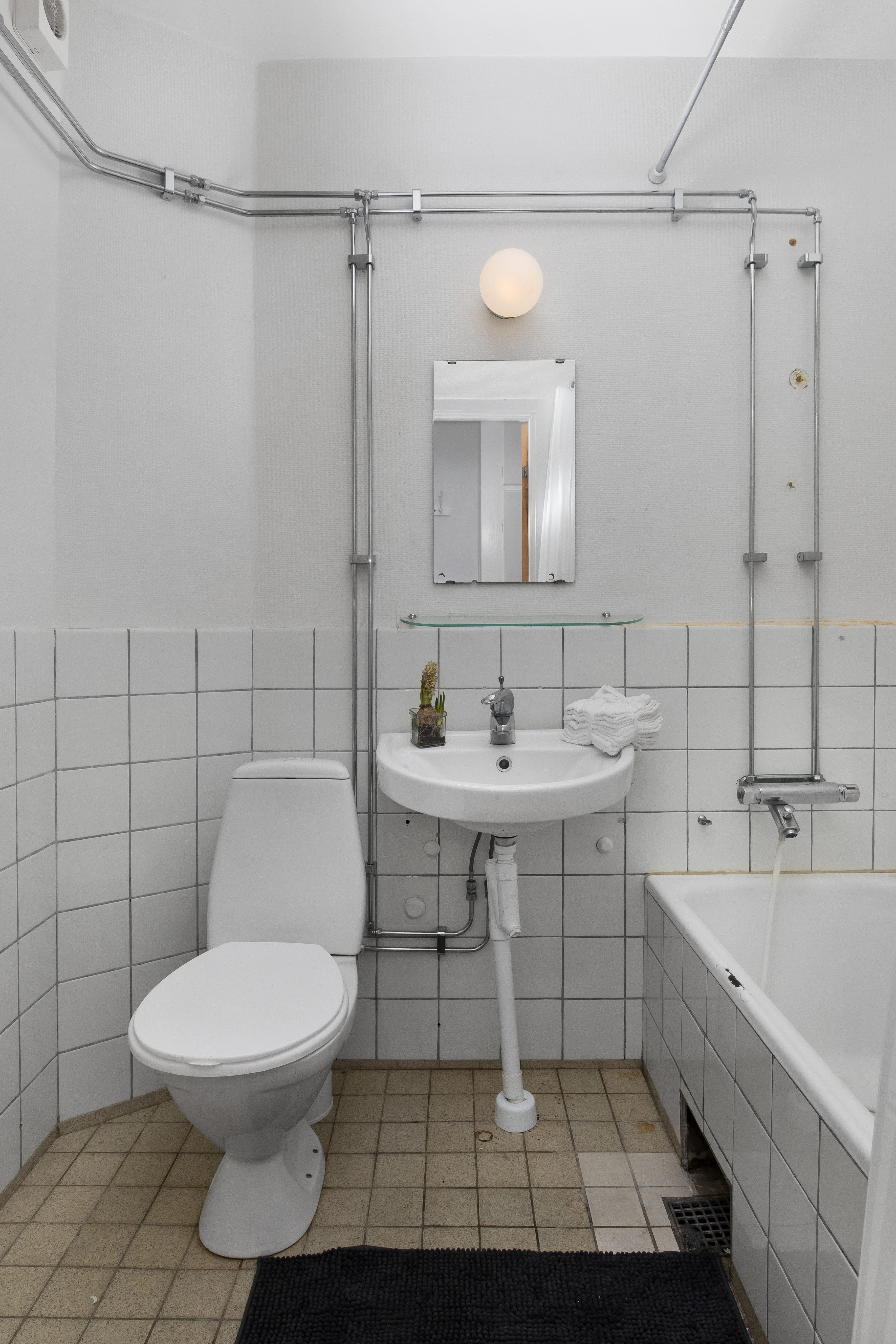 A shower head on a tile floor