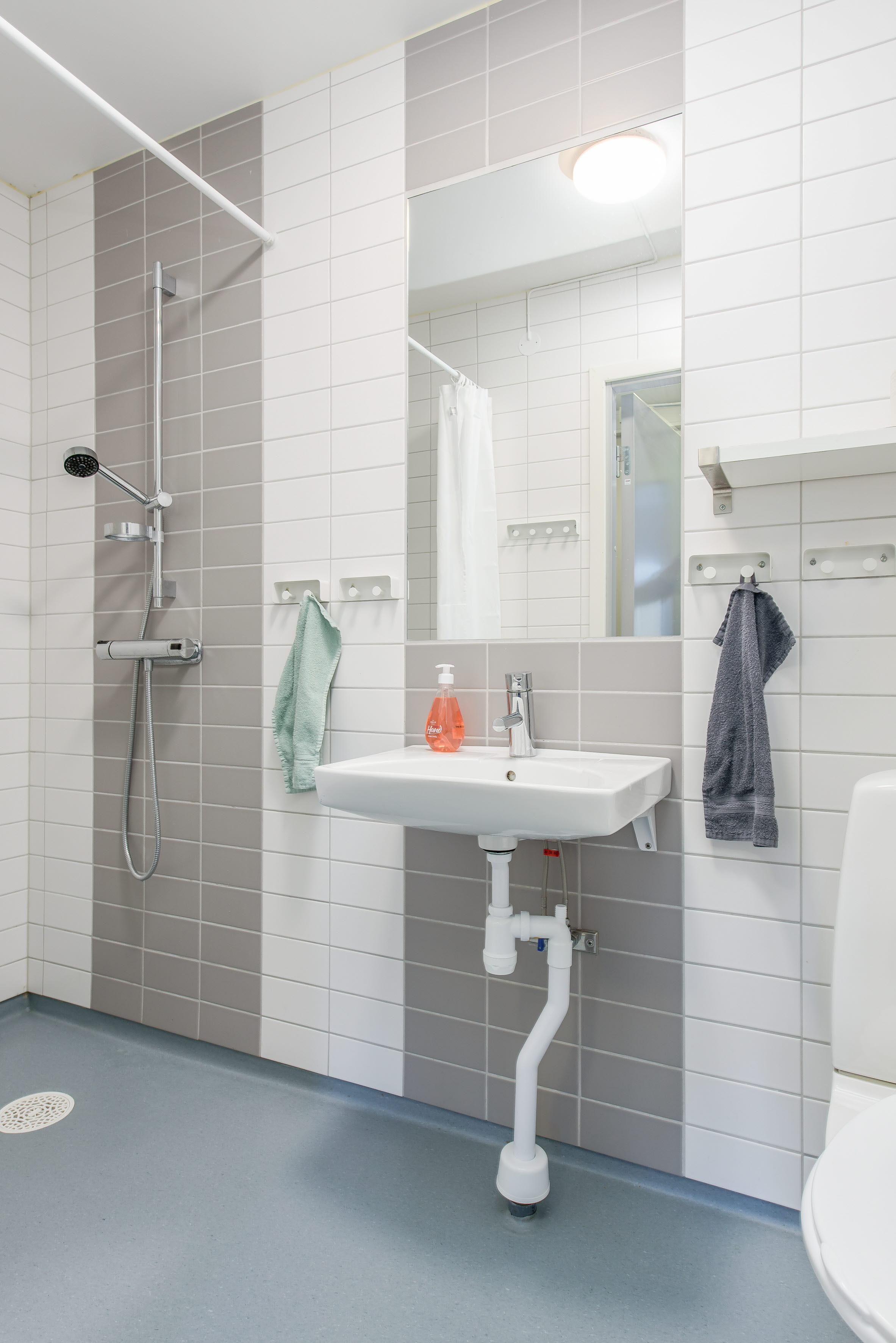 A room with a sink and a mirror