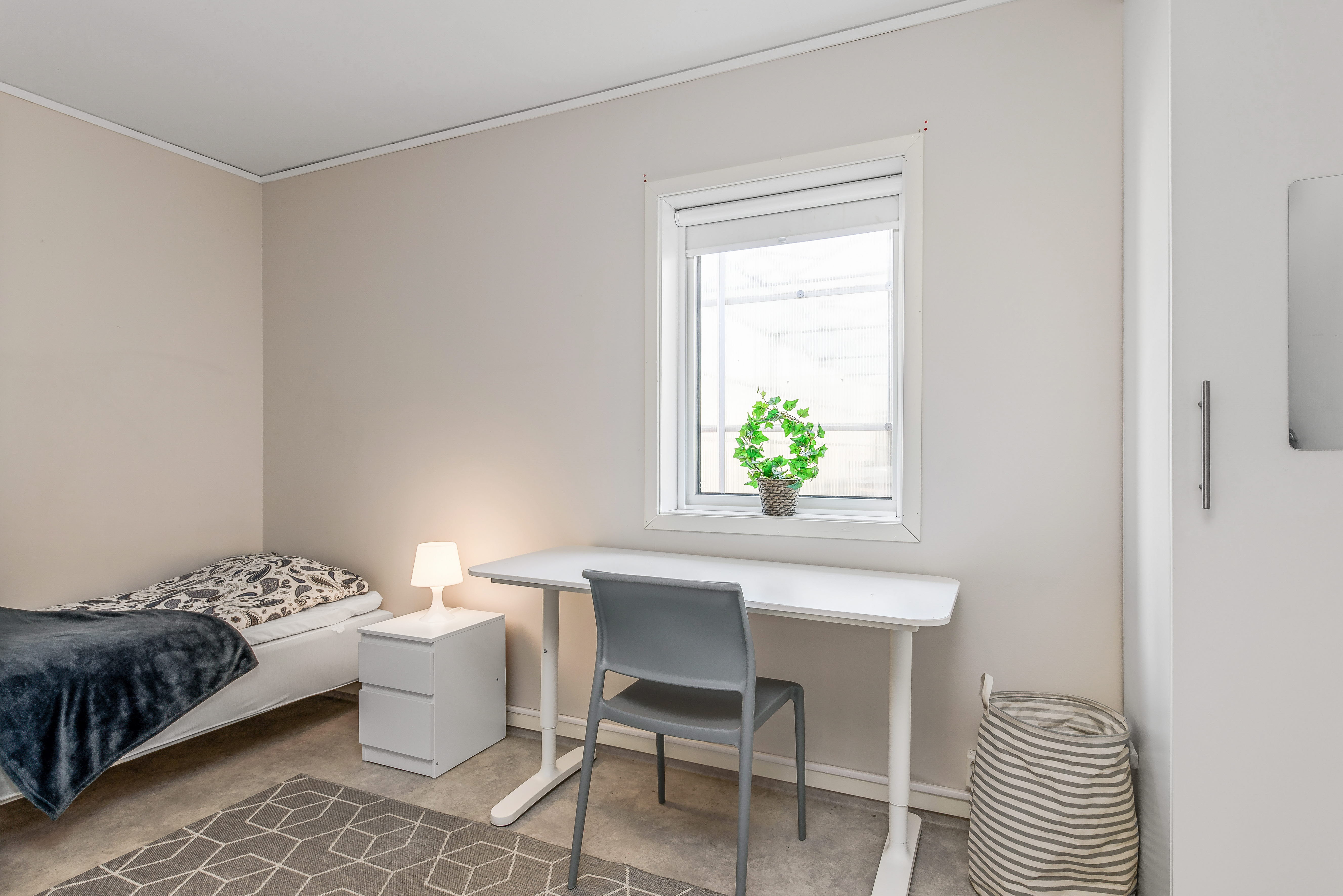 A bedroom with a bed in a room