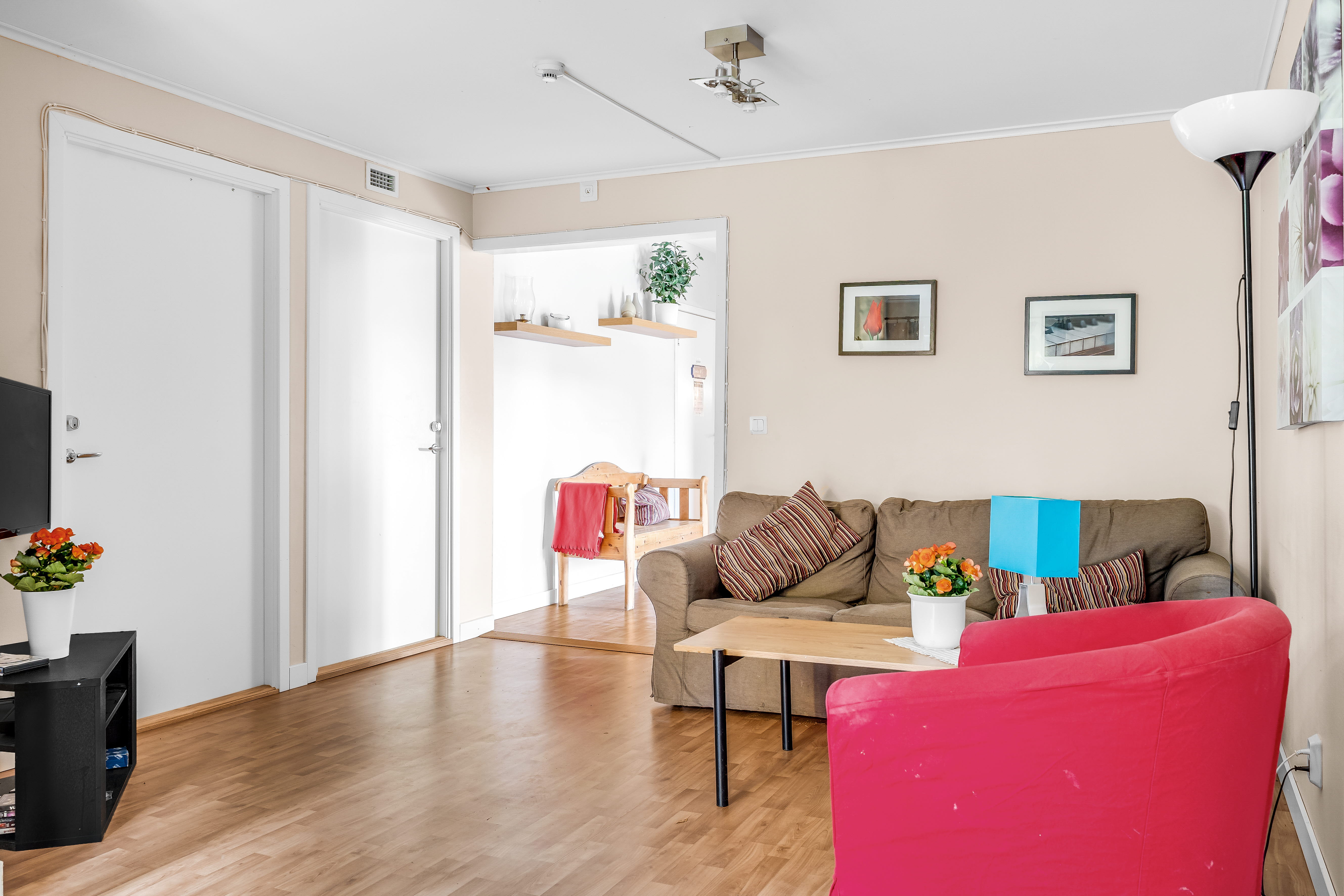 A living room filled with furniture on top of a hard wood floor