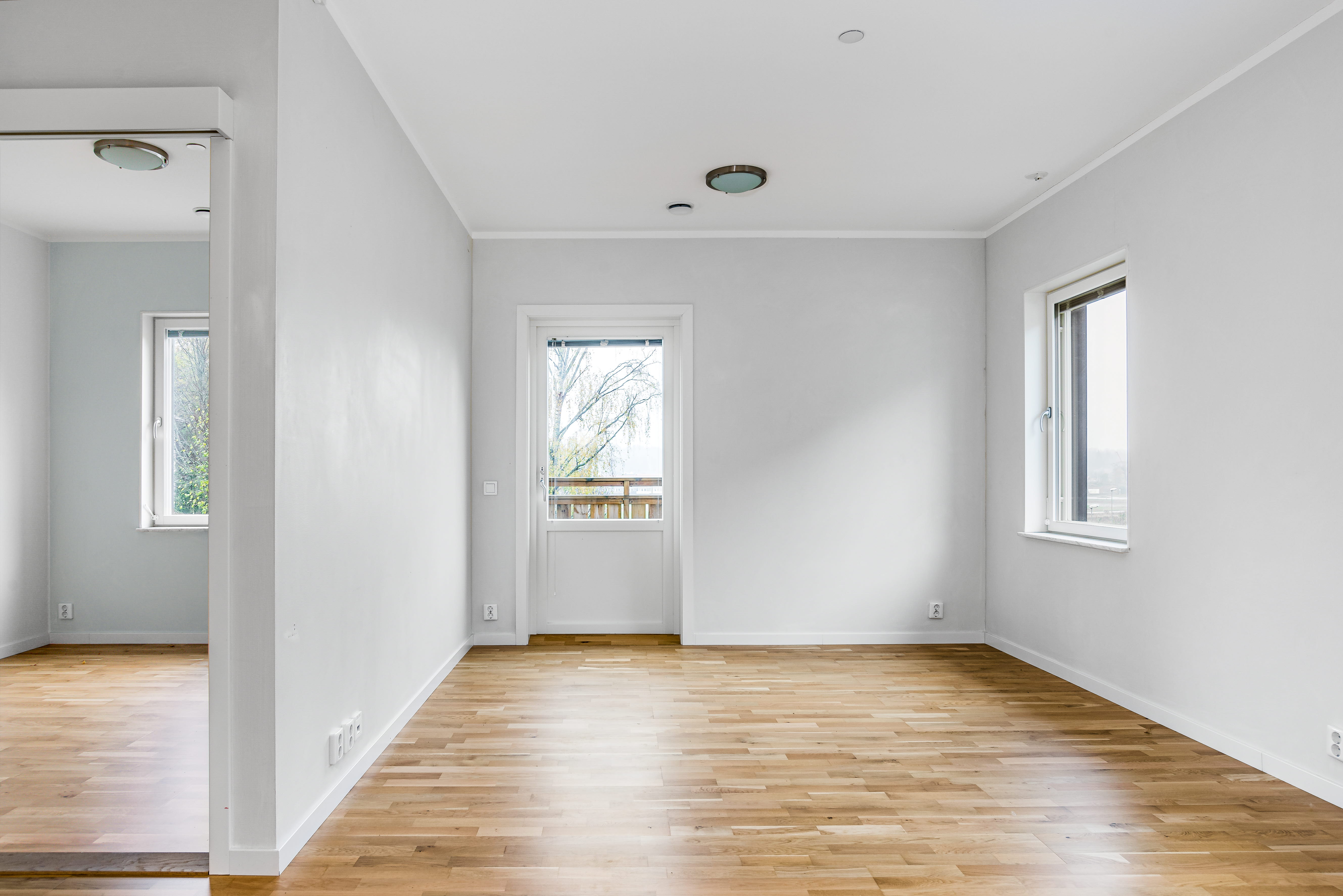 A large empty room with a hard wood floor
