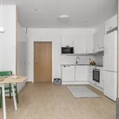A kitchen with a table in a room