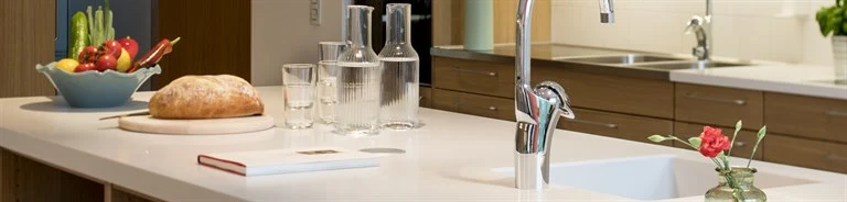 A kitchen with a sink and a mirror