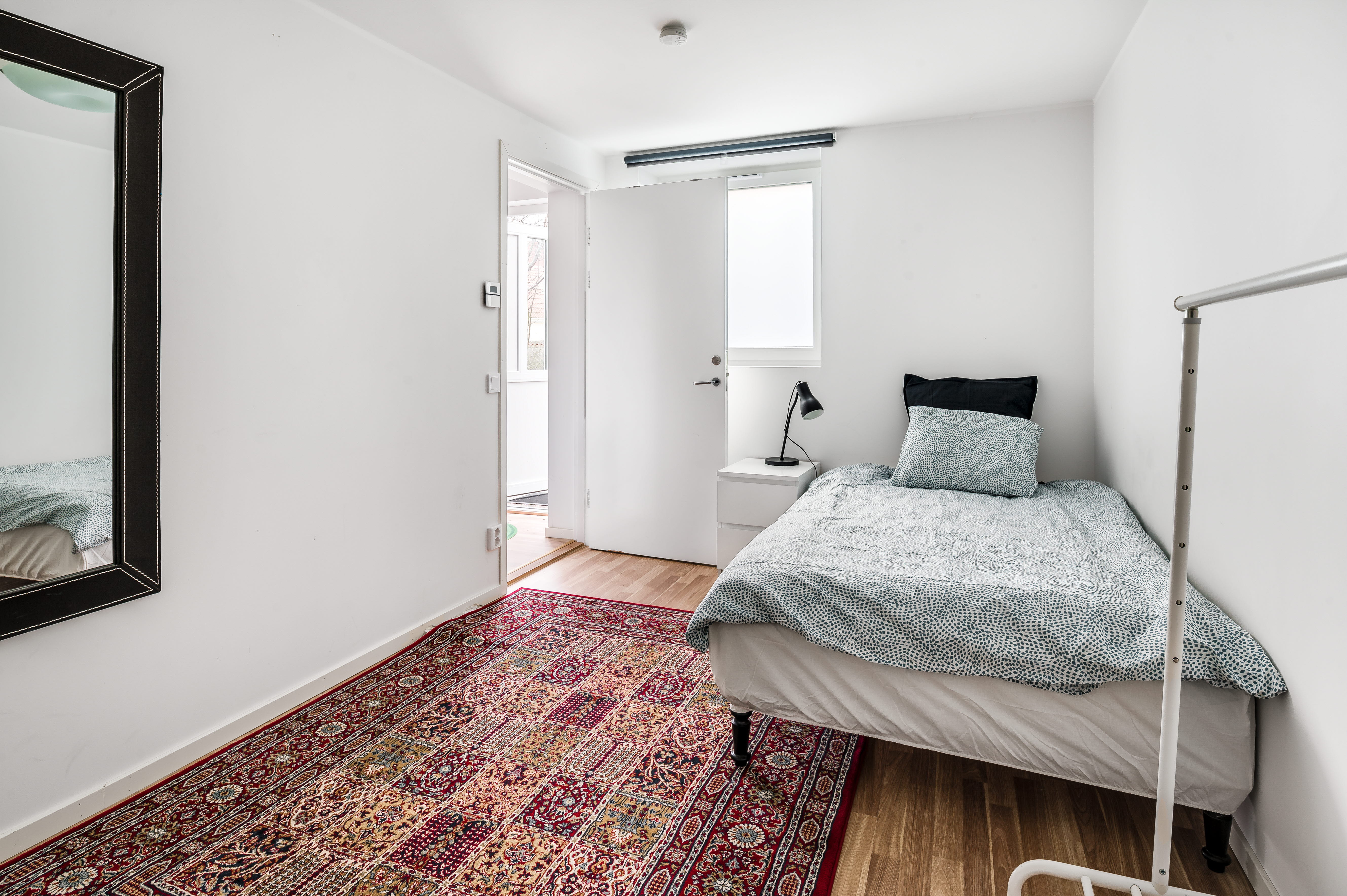 A bedroom with a bed in a room