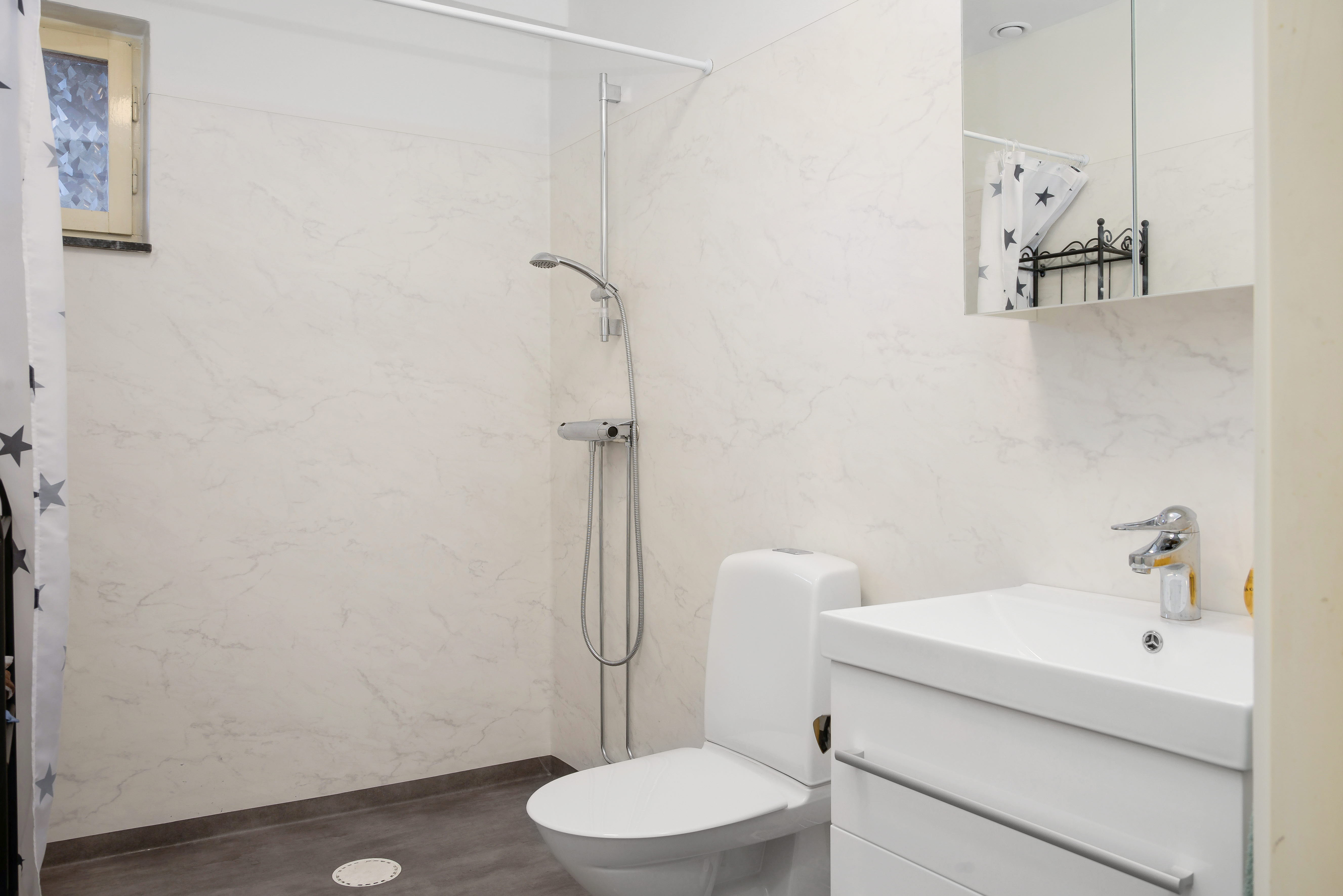 A shower that has a sink and a mirror