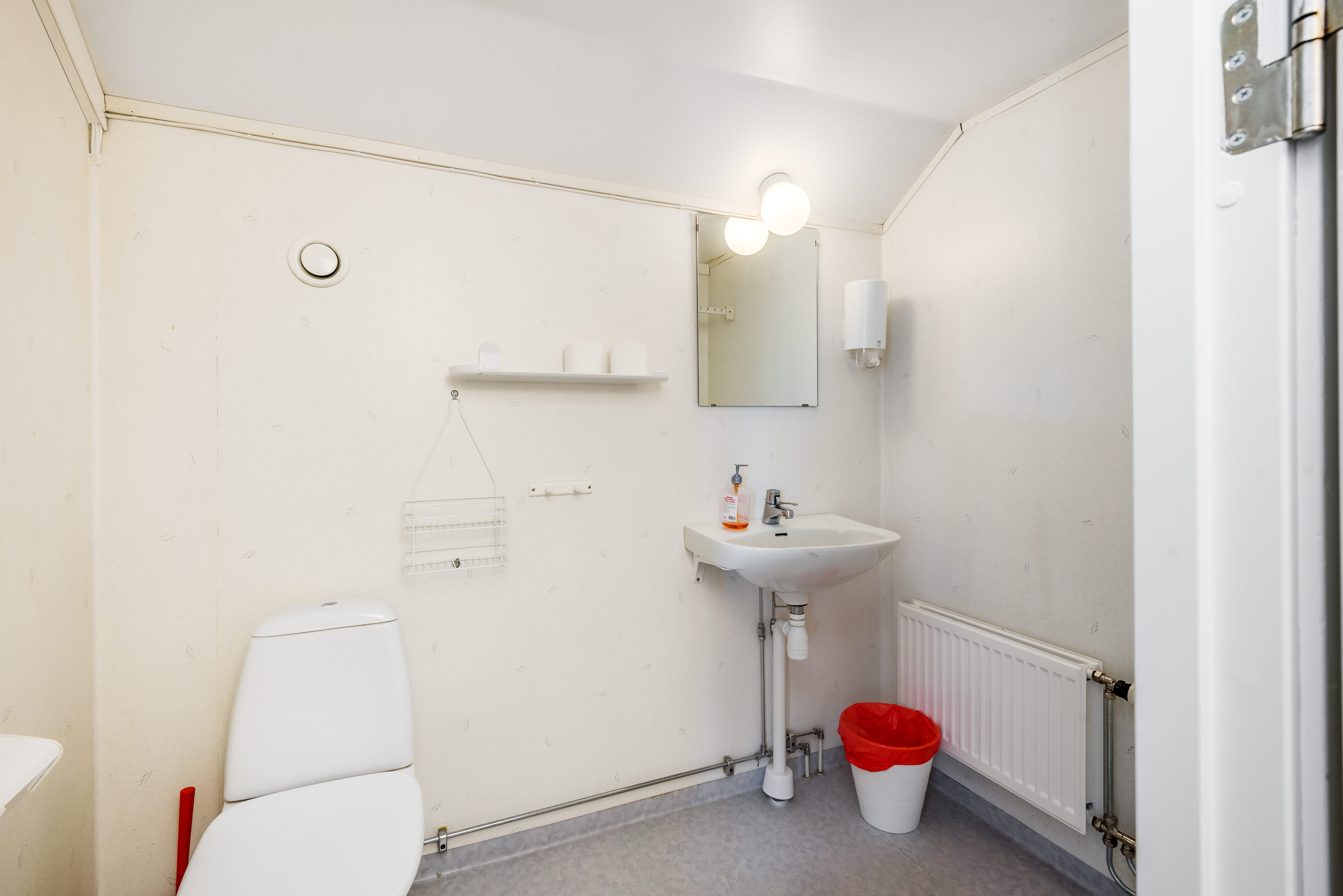 A room with a sink and a mirror