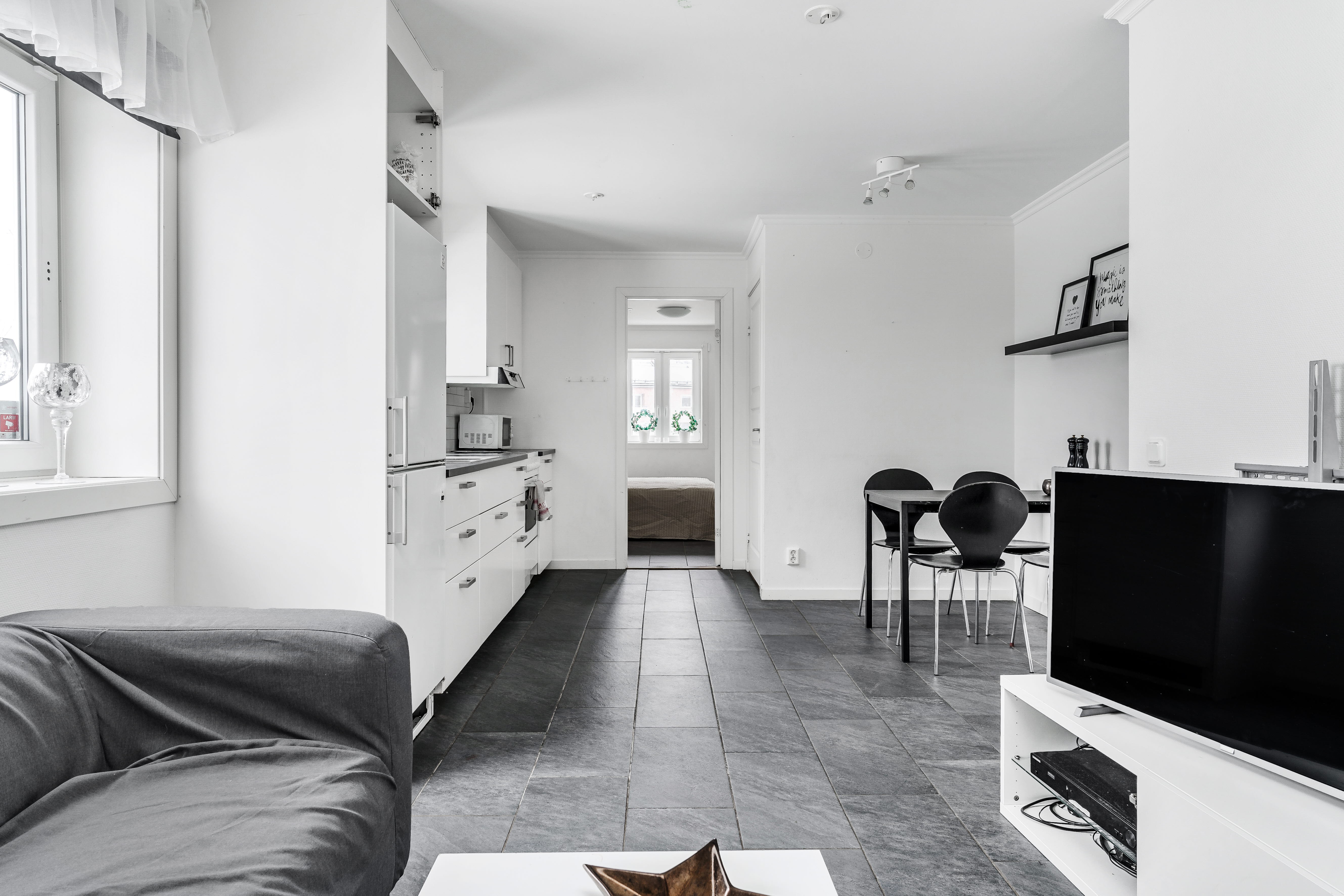 A living room filled with furniture and a flat screen tv