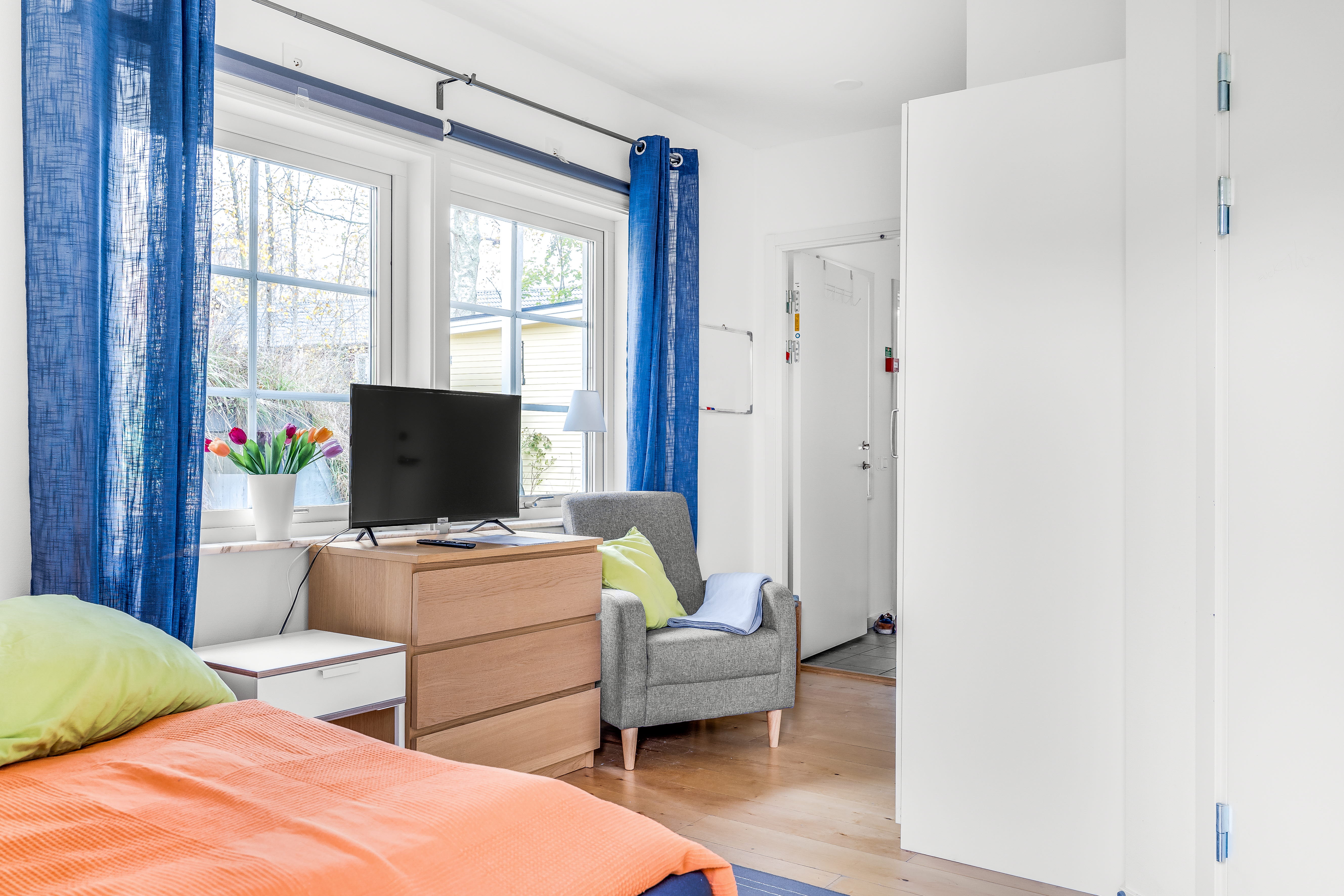 A bedroom with a bed in a room