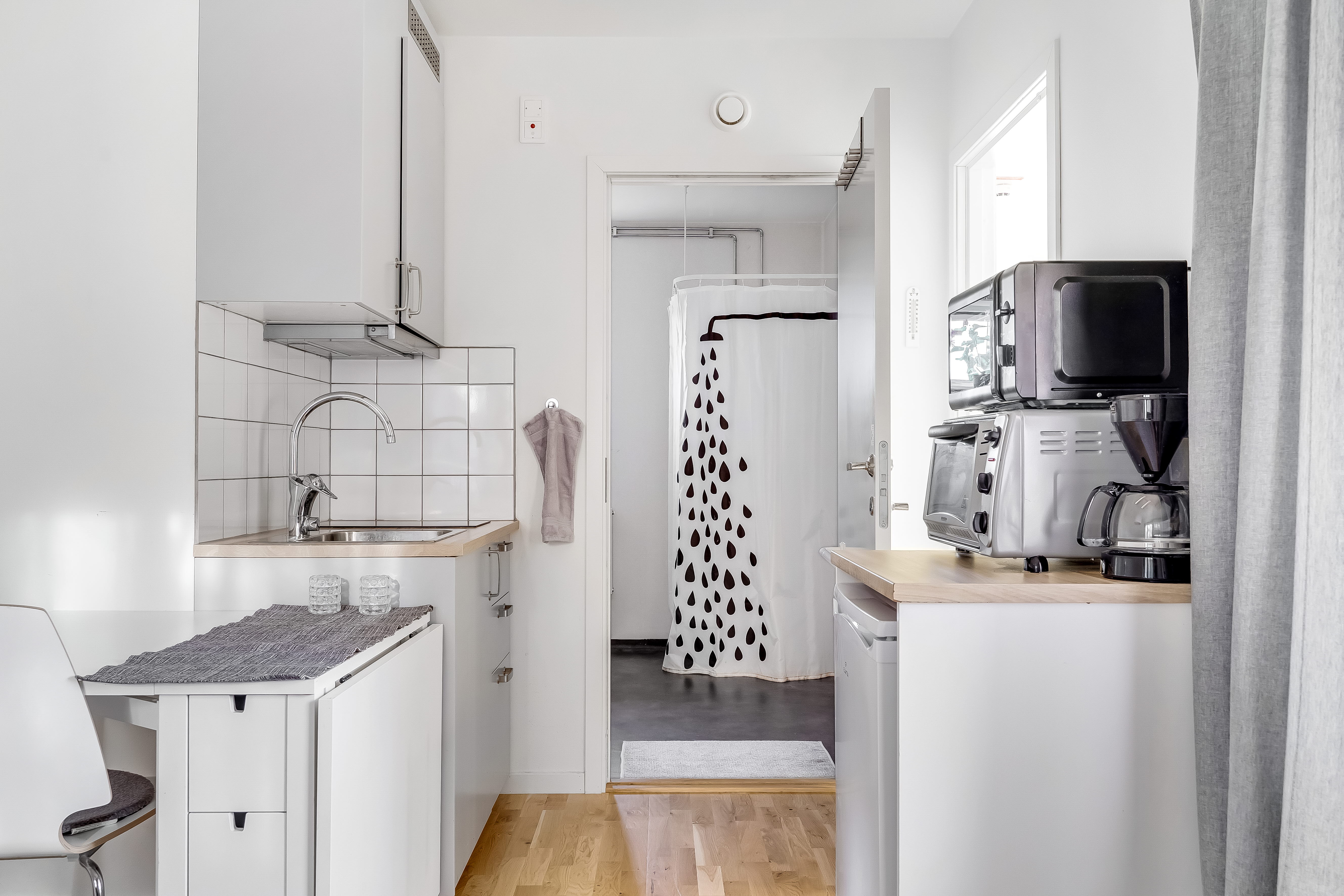 A kitchen with a sink and a microwave